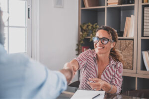 Recruitment case studies - an image of a pretty recruiter consultant shaking hands